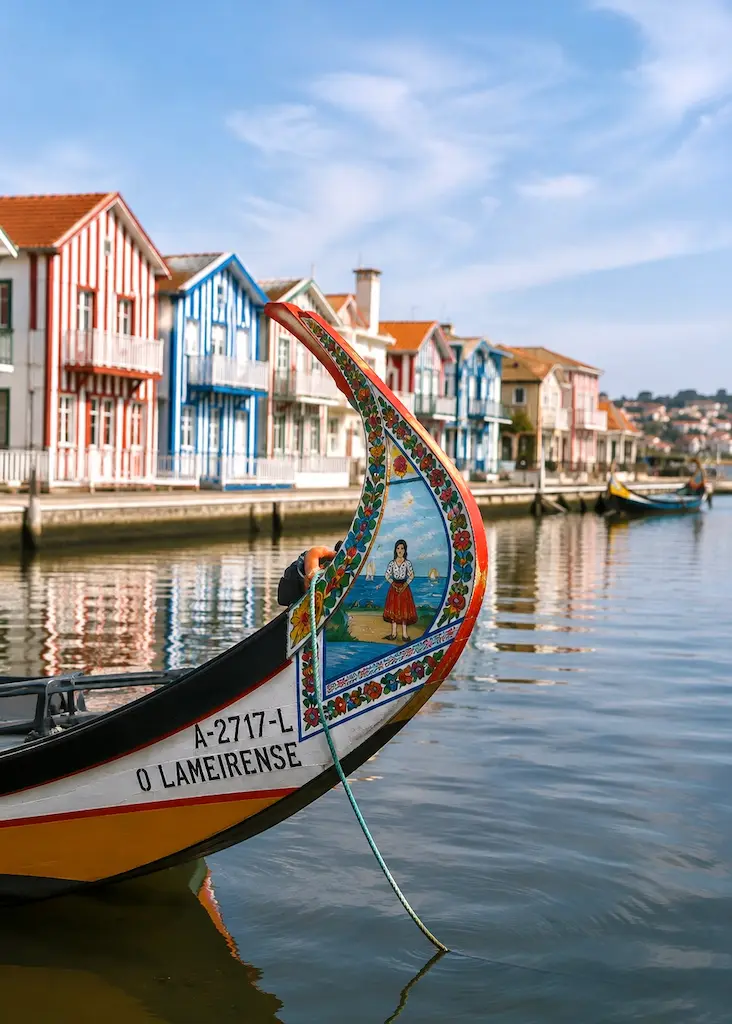 Traditional brightly painted moliceiro boat floating on the calm waters of the Ria de Aveiro in Portugal