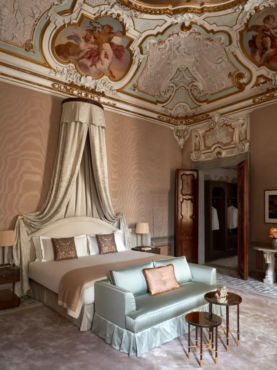 Colori Persi Suite at Orient Express Venezia with a richly painted ceiling above a contemporary bedroom.