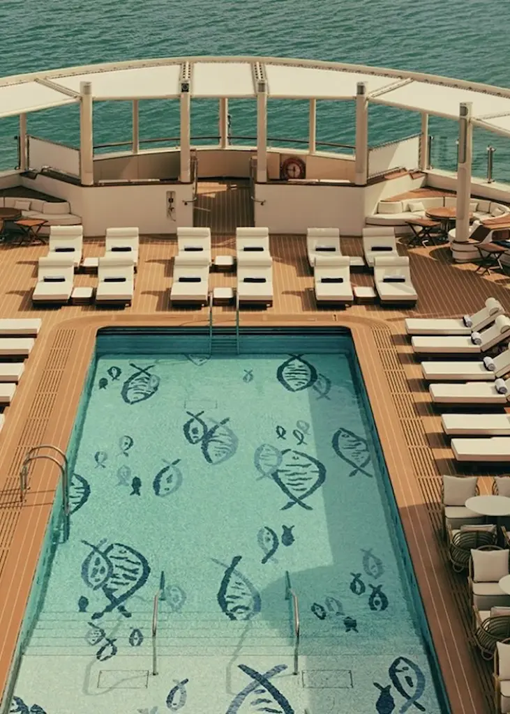 Swimming pool and sun loungers on the deck of Four Seasons I overlooking the sea.