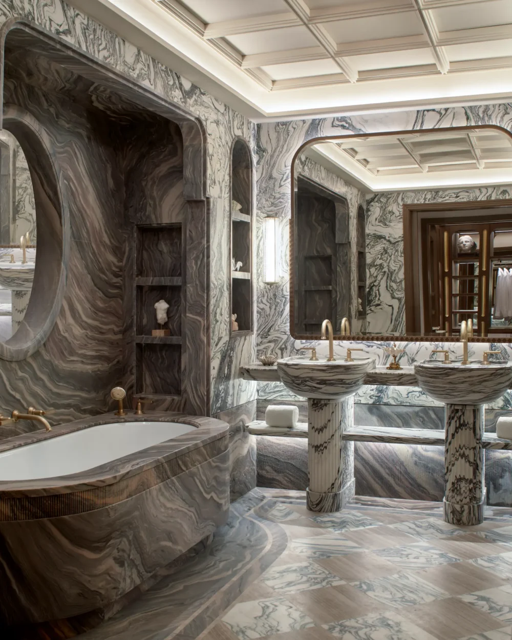 Marble bathroom at Orient Express Venezia with a freestanding bathtub, sculptural stone surfaces and soft natural light.