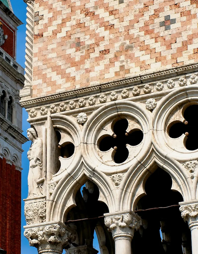 Sunlight passing through weathered Venetian Gothic stone tracery above the lagoon, revealing intricate carved openings and shadows.