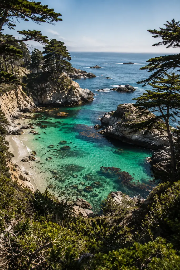Emerald water and rocky cliffs at China Cove in Point Lobos State Natural Reserve near Carmel, California