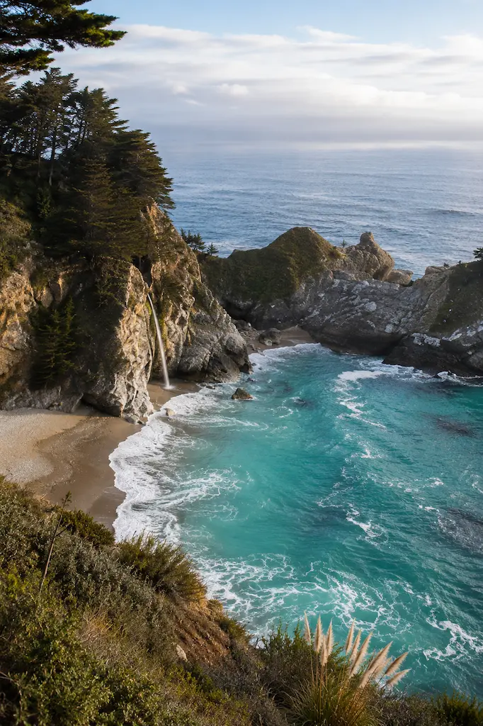 McWay Falls dropping from a rugged Big Sur cliff into a secluded turquoise cove on the California coast