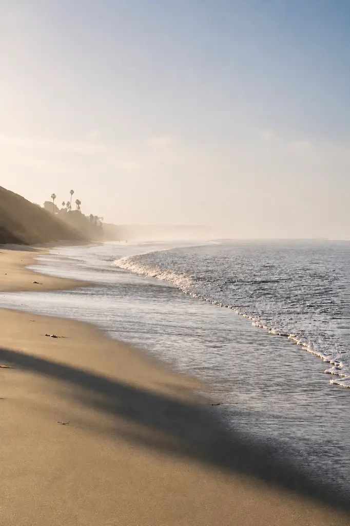 Soft morning mist and gentle Pacific waves along the beach at Cardiff-by-the-Sea, California